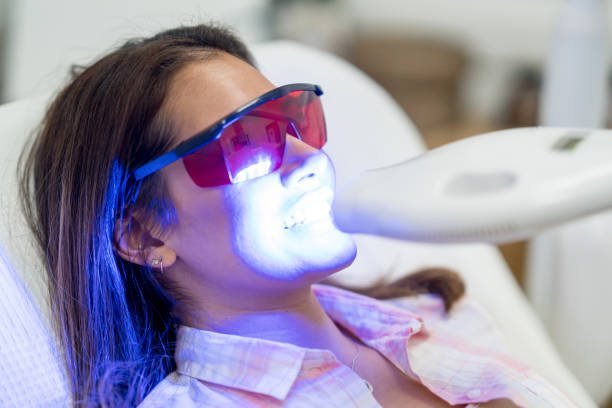 Patient receiving in-office laser teeth whitening